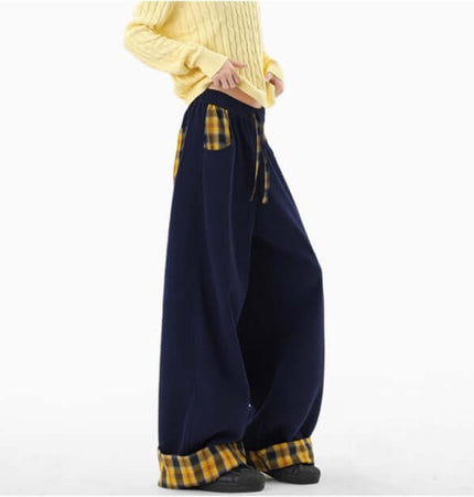 Model wearing Loose Wide-Leg Sweatpants with a yellow sweater and visible plaid pockets.