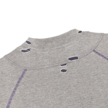 Close-up of the Punk Distressed Short Sleeve T-Shirt – Loose Fit featuring intentional ripped hole detailing.