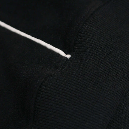 Close-up of the sleeve detail of a Faux Suede Printed Hoodie – Loose Fit showcasing fabric texture and design.