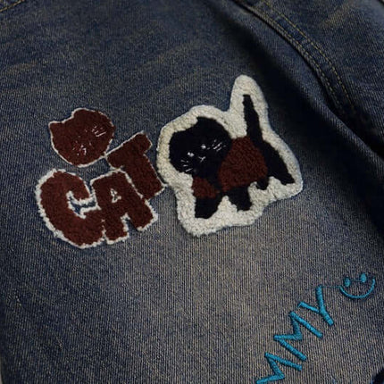 Vintage Washed Cartoon Embroidered Jeans featuring playful cat embroidery on denim fabric.