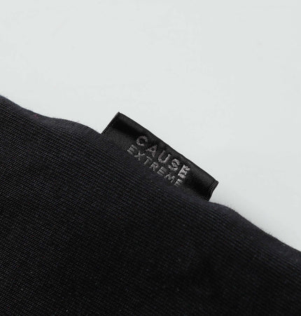 Close-up of a label on a black fabric featuring 'CAUSE EXTREME' text, highlighting quality craftsmanship.