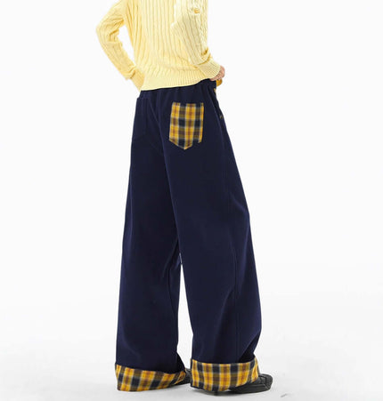 Model showcasing Loose Wide-Leg Sweatpants with a cozy yellow sweater and plaid accents.