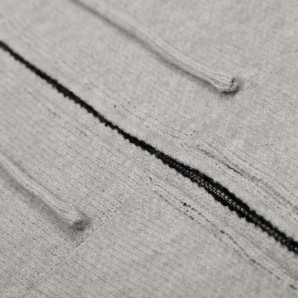 Close-up of the Letter Jacquard Knit Hoodie – Loose Fit showcasing soft gray fabric and bold letter patterns.