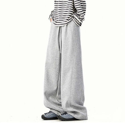 Heavyweight Wide-Leg Pants - Loose Fit worn with a striped long-sleeve shirt and stylish sneakers.