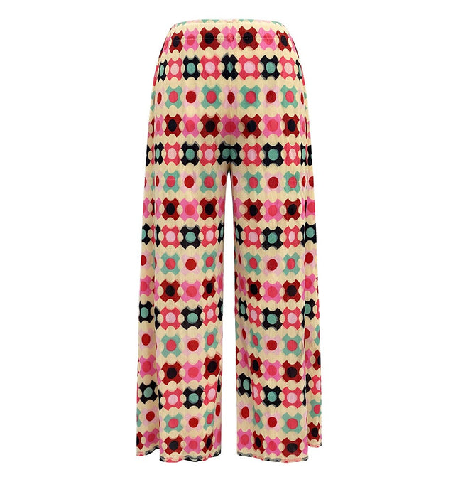 Colorful wide-leg pants with geometric print in shades of red, pink, green, and black.