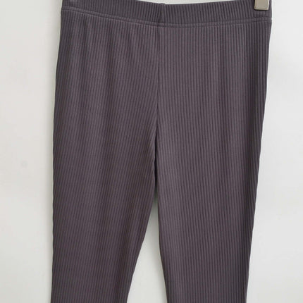 Slim Fit Low Waist Slightly Flared Pants hanging on a wooden hanger showcasing the ribbed texture.