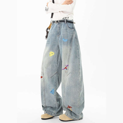 Knife-Cut Embroidered Pants – Loose Fit featuring a loose silhouette and colorful embroidery accents on washed denim.