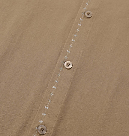Minimal Casual Loose Short Sleeve Shirt featuring a close-up of buttons and subtle stitching on fabric.