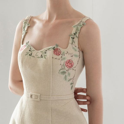 Elegant off-white embroidered dress with floral patterns on cotton polyester fabric, representing organic, relaxed, and chic fashion in size S, M, L