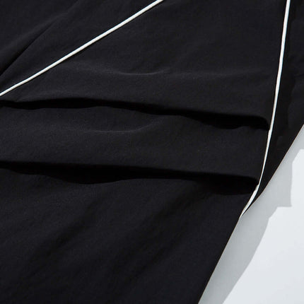 Tape Decorated Casual Wide-Leg Pants fabric close-up showing contrast tape detailing and smooth texture.