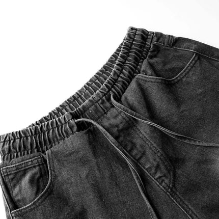 Distressed Pleated Reverse Denim Pants showing elastic waistband and side pockets in a dark washed finish.