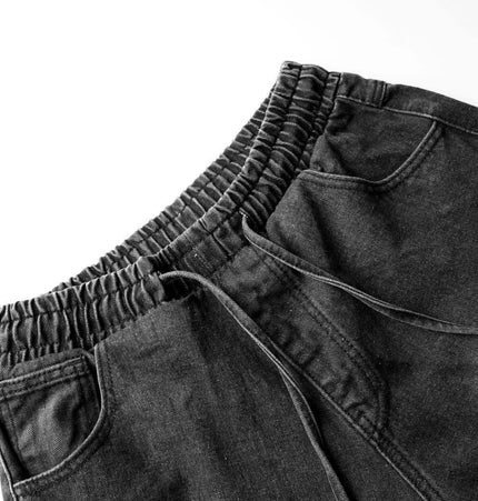 Distressed Pleated Reverse Denim Pants showing elastic waistband and side pockets in a dark washed finish.