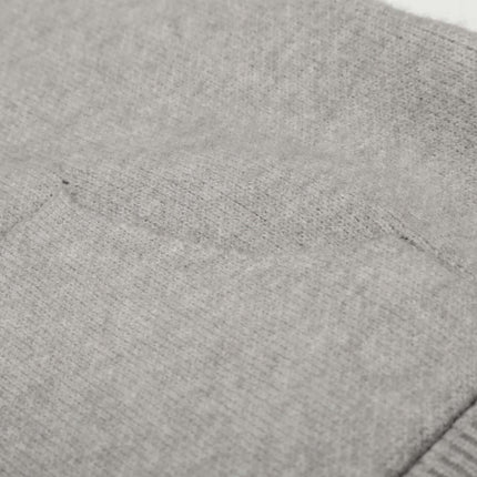 Close-up of the soft gray fabric and pocket detail from the Letter Jacquard Knit Hoodie – Loose Fit.