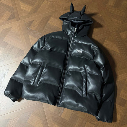 Devil Ears Leather Hoodie Jacket – Loose Fit displayed on a wooden surface, showcasing its unique design and cozy style.
