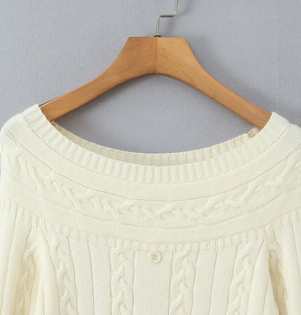 Off-Shoulder Twists Slim Knit Sweater on a wooden hanger showcasing its elegant design and cable knit texture.