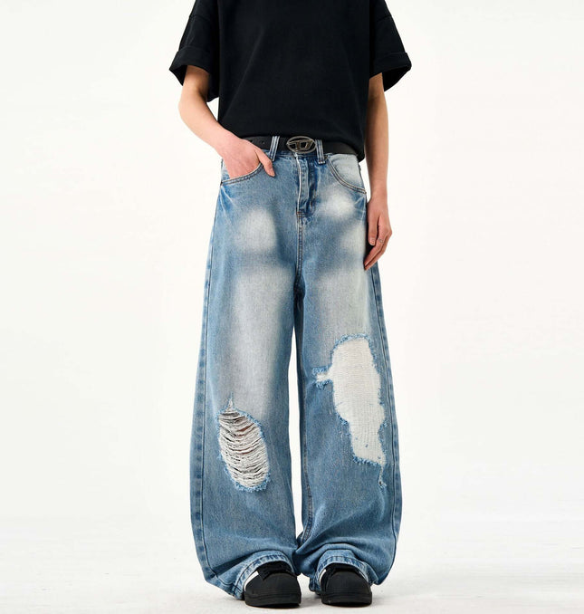 Casual Ripped Light Blue Jeans – Loose Fit worn by a person, showcasing the vintage ripped detailing and loose fit.