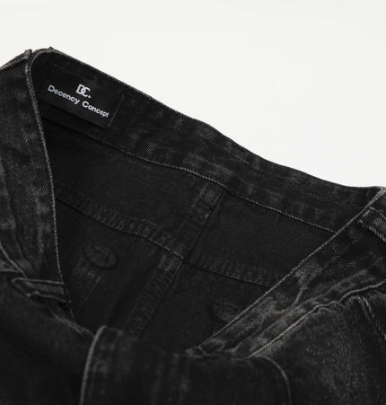 Washed Black Vintage Knife Cut Jeans close-up image showing the waistband and tag for style detail.