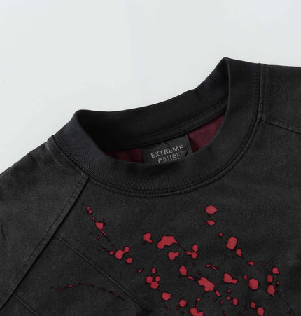 Retro Splatter Print TShirt – Loose Fit close-up view showing black fabric and splatter design.