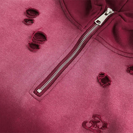 Close-up of the Half-Zip Printed Hoodie – Loose Fit showcasing dark red fabric with distressed details and silver zipper.