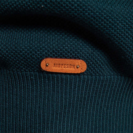 Close-up of the label on a Stand Collar Half-Zip Knit Sweater in a soft cotton blend fabric.