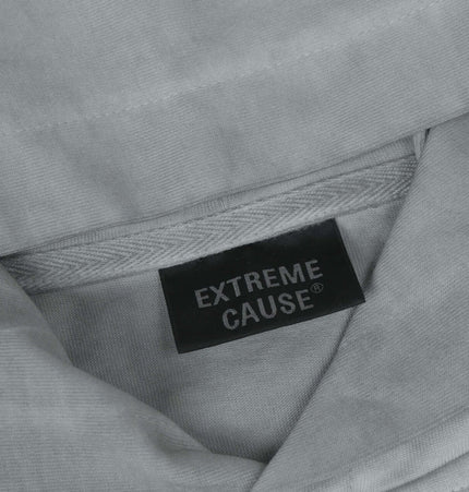 Close-up of the label of a Retro Letter Print Hoodie – Loose Fit with Extreme Cause branding.