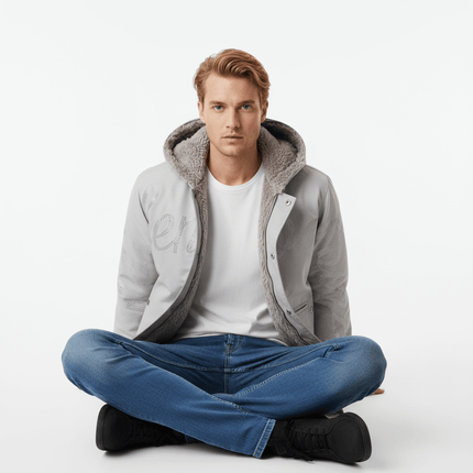 Model wearing the Hawk Embroidered Letter Hooded Coat sitting cross-legged on a white background.