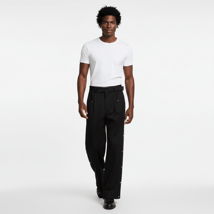 Stylish man wearing Wide Leg Pleated Plaid Trousers with a white t-shirt, showcasing casual streetwear appeal.