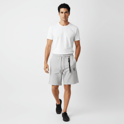 A man wearing Straight Leg Drawstring Shorts – Loose Fit and a white t-shirt, walking confidently in a casual setting.