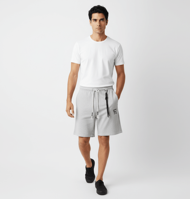 A man wearing Straight Leg Drawstring Shorts – Loose Fit and a white t-shirt, walking confidently in a casual setting.