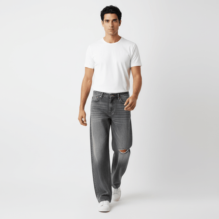 Model wearing Washed Distressed Denim Pants with a white t-shirt, showcasing casual street-style appeal.