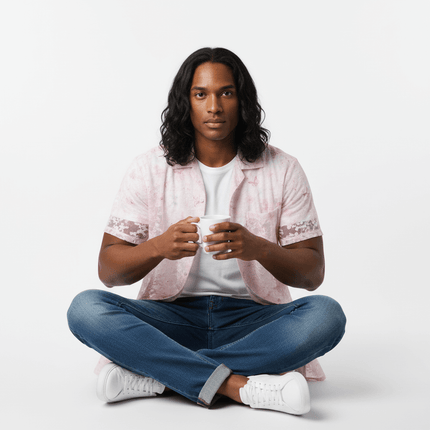 Model wearing a Butterfly Jacquard Printed Shirt, sitting cross-legged and holding a mug, showcasing its retro style.