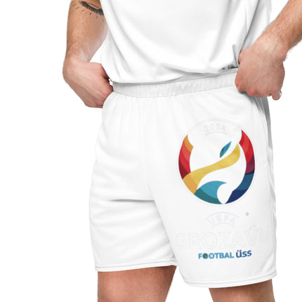 Football fan wearing white UEFA Grozavu Mesh Shorts with colorful logo, showcasing organic cotton material and relaxed fit for ultimate comfort.