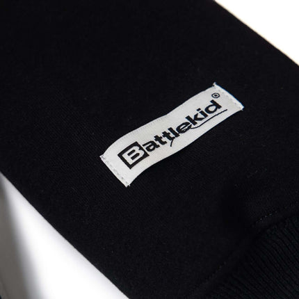 Close-up of the Battlekid label on a black hoodie sleeve, showcasing premium quality and design.