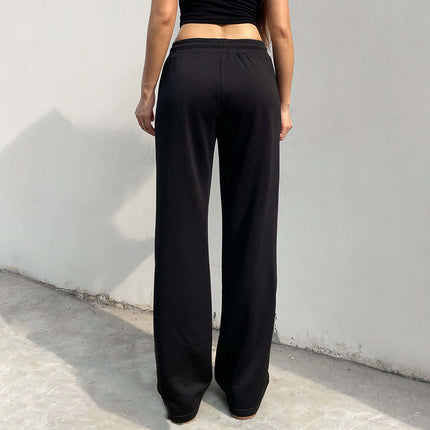 Black Sport Casual Pants – Loose Fit, showcasing a woman's back view in relaxed, wide-leg black pants.