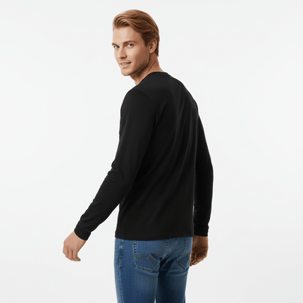 Man showcasing the Bottom Knit Long Sleeve Pullover in black, turned slightly to highlight its stylish design.