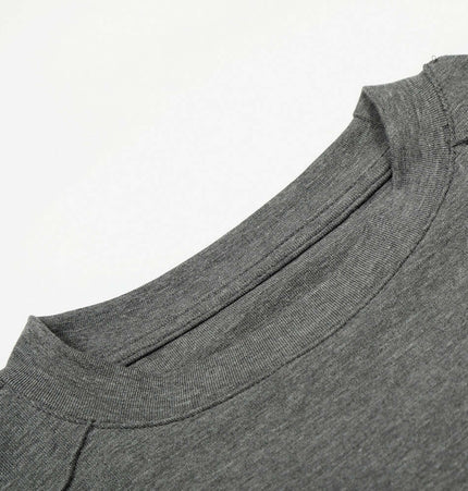 Close-up view of the neckline of the Bottom Knit Long Sleeve Pullover in medium gray.