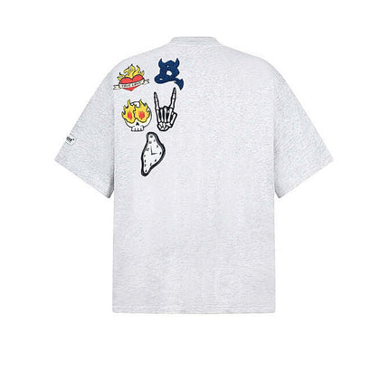 Cartoon Badge Cotton TShirt – Loose Fit featuring playful cartoon graphics on the back with a trendy drop-shoulder style.