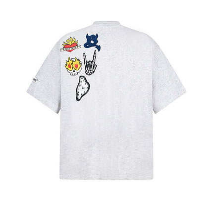 Cartoon Badge Cotton TShirt – Loose Fit featuring playful cartoon graphics on the back with a trendy drop-shoulder style.
