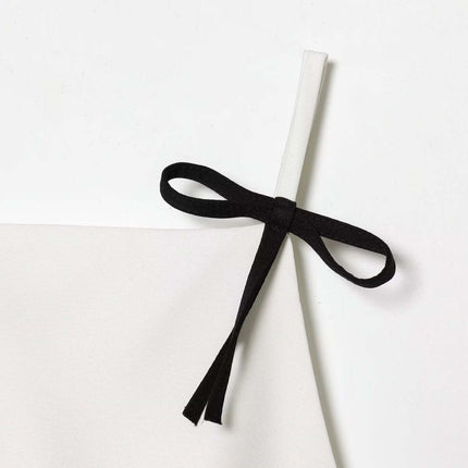 Casual Bow Detail Strap Top – Slim Fit showing a cute black bow detail on a solid white strap.