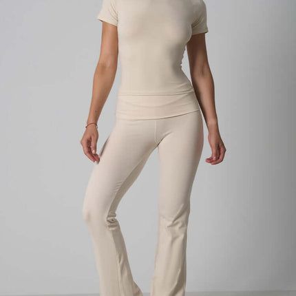 Casual Fit Cotton Jersey Yoga Set featuring a short sleeve crop top and high-waist long flare pants in beige.
