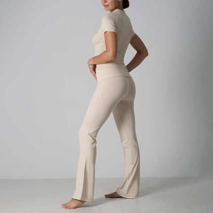 Casual Fit Cotton Jersey Yoga Set showcasing a stylish woman in a beige short sleeve crop top and high-waist flare pants.