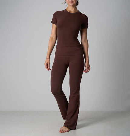 Casual Fit Cotton Jersey Yoga Set modeled by a woman in brown short sleeve crop top and high-waist long flare pants.
