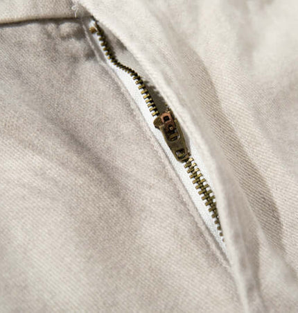 Close-up of zipper detail on a garment showcasing quality craftsmanship and fabric texture.