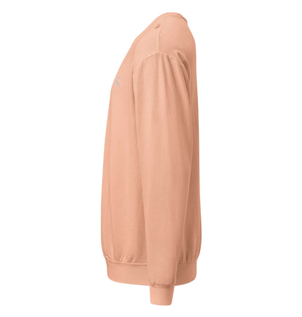 Comfort Colors 1466 Lightweight Crewneck side view in soft peach color, showcasing relaxed fit and ribbed cuffs.