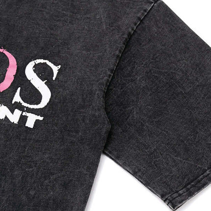 Cross Print Vintage TShirt – Loose Fit showing black fabric with colorful print detail on sleeve.