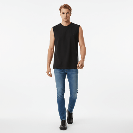 Model wearing Distressed Sport Tank Top – Loose Fit with jeans, showcasing a casual streetwear style.