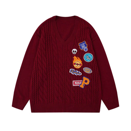 Embroidered Cable Knit VNeck Sweater with colorful patches on a red background, showcasing premium detailing and texture.