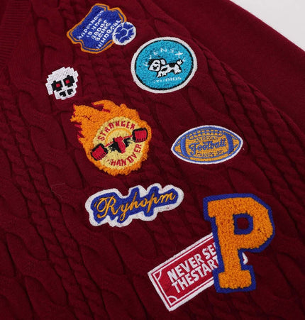 Close-up of the embroidered patches on the Embroidered Cable Knit VNeck Sweater showcasing unique designs.