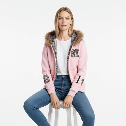 Fleece Lined Leopard Ears Hoodie modeled by a woman sitting on a stool, featuring a pink color and leopard ear hood.