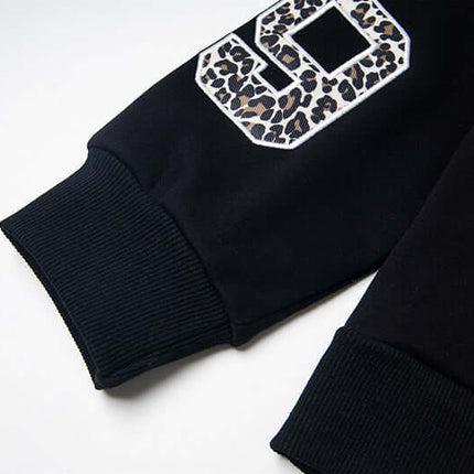 Detail of the Fleece Lined Leopard Ears Hoodie featuring leopard print accents on sleeves.